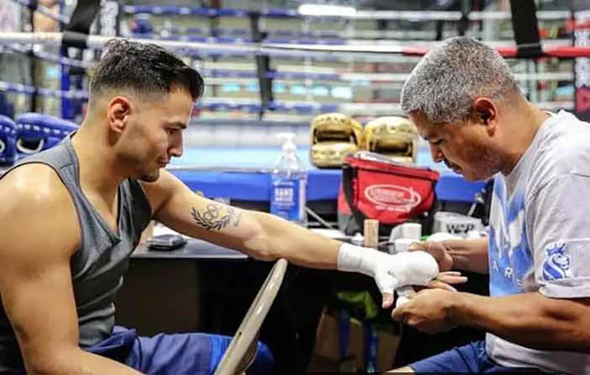 Lindolfo Delgado gets his hands wrapped by trainer Robert Garcia at the Robert Garcia Boxing Academy in Moreno Valley, California.